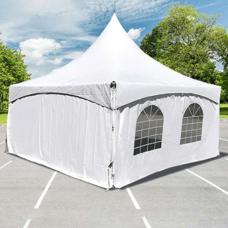 White high peak event tent with sidewalls and arched window panels set up on a paved surface outdoors