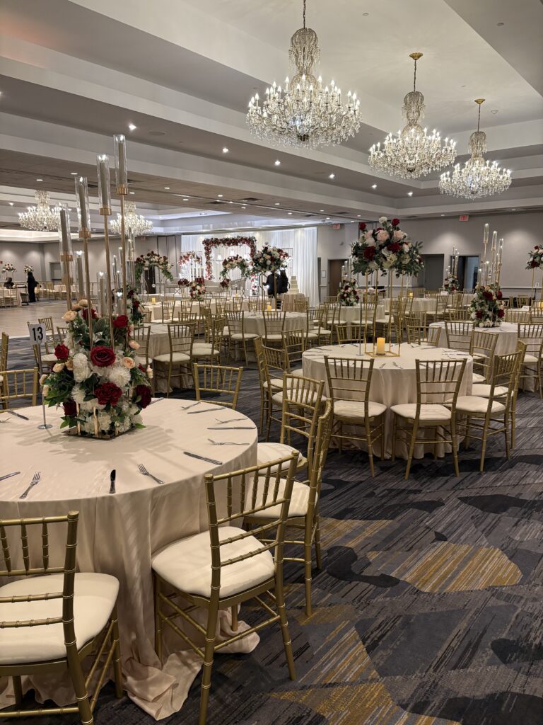 Table and chair rentals in Middlesex, NJ featuring gold chiavari chairs and wooden event tables