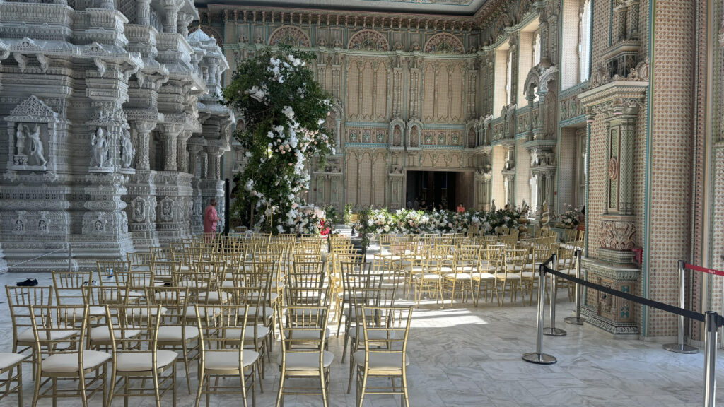 Gold Chiavari chairs arranged for a wedding ceremony inside an ornate venue near Edison, NJ